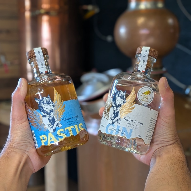2 bouteilles de spiritueux de la distillerie Saint loup : le pastis et le gin london dry